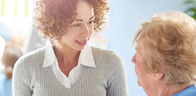 Older and younger woman having a conversation Older and younger woman having a conversation