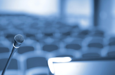 a close-up of a microphone on a stand in a conference room 