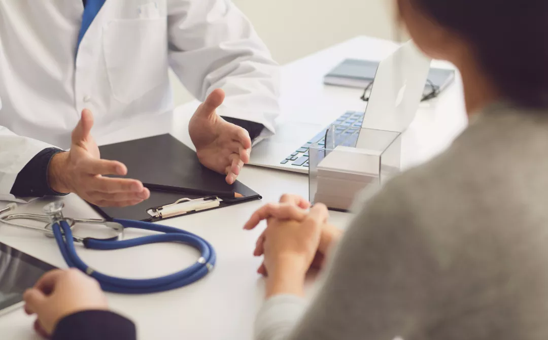 Patients sitting at a table during a doctors consult